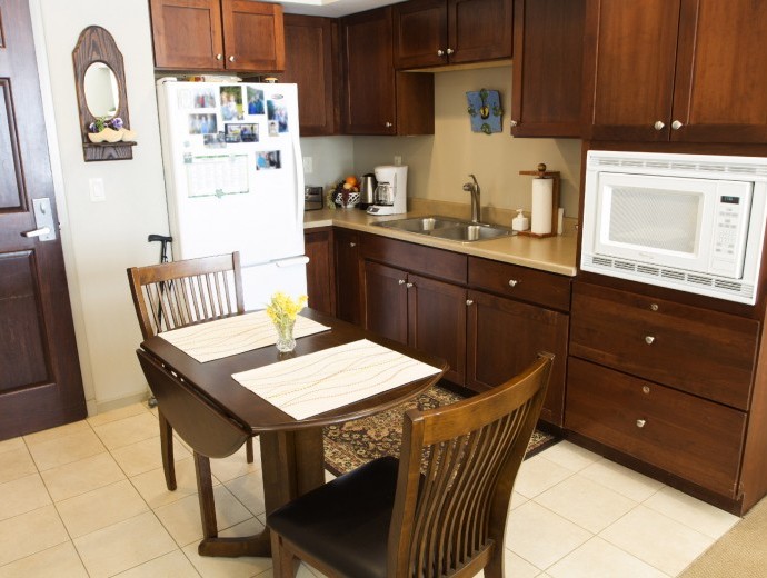 Quaint kitchen with dining table available in the assisted living apartments at Good Samaritan Society - Prairie Creek Village in Sioux Falls, South Dakota.