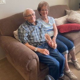 Diane Nichols' parents smiling in the living room of their new home at Good Samaritan – Prairie Creek.