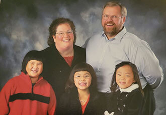Jerry Kjer and his late wife, Lee Ann, with their three daughters, Ginny Lu, Lucy Mei and Ellie Meng.
