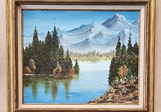 Leona Russell's painting of a lake and mountains.