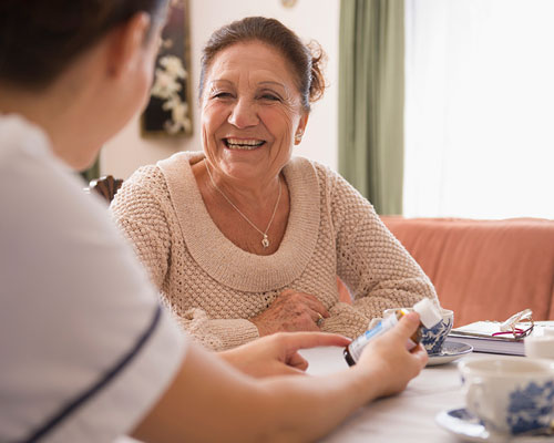 Woman discussing medications with a medical professional.