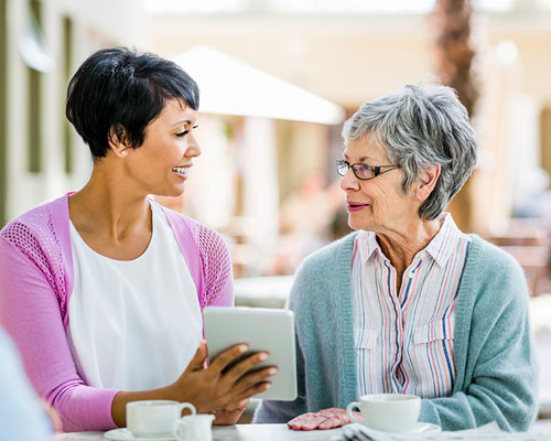 2 ladies with a tablet.