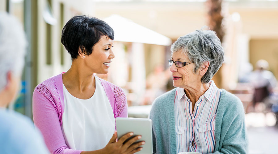 2 ladies with a tablet.
