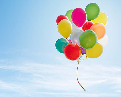 Colorful balloons floating high in the sky.