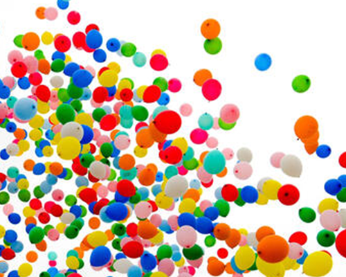 Lots of colorful balloons floating into the air.