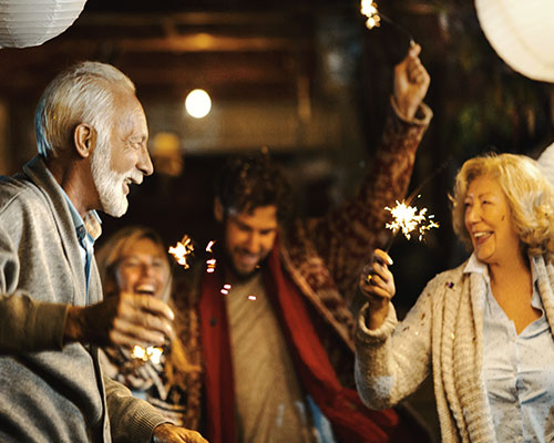 People dancing with sparklers.