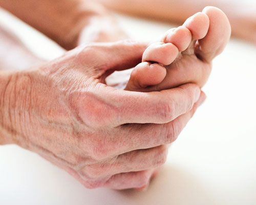 Hand massaging a foot.