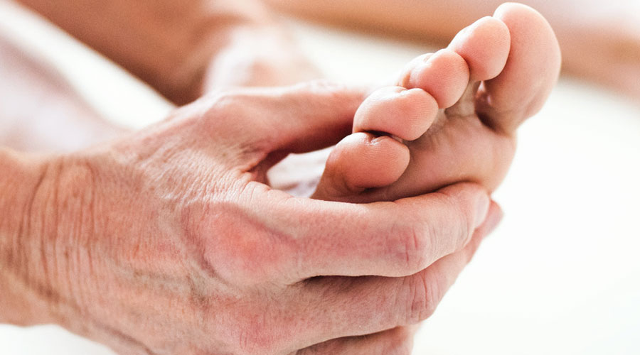 Hand massaging a foot.