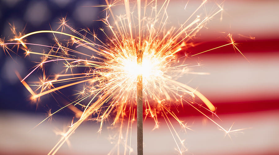 Sparkler in front of an American flag