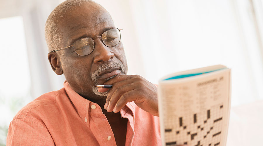 Man doing a crossword puzzle.