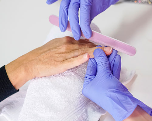 Filing finger nails.