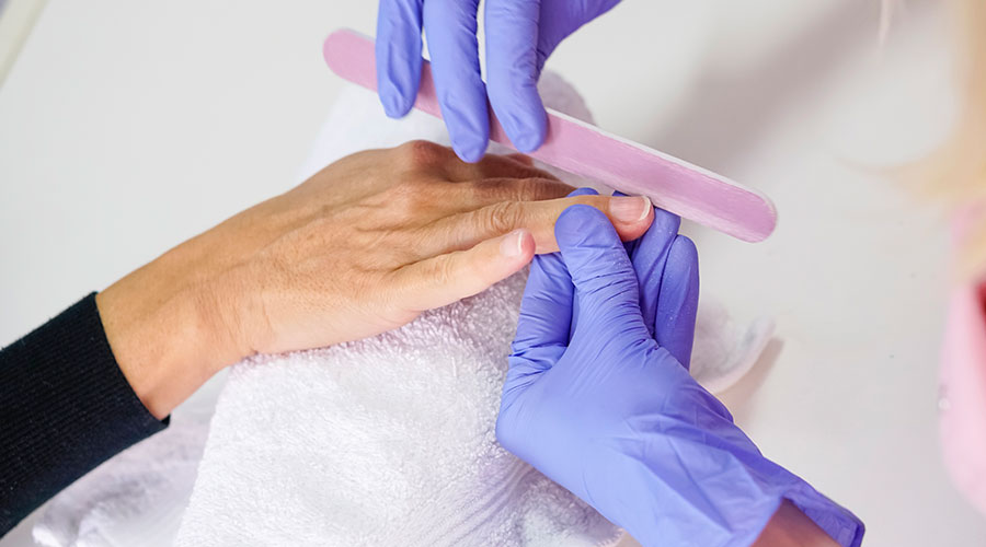 Filing finger nails.