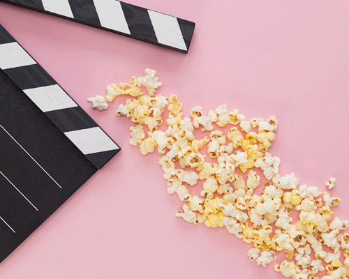Popcorn and movie clapperboard.