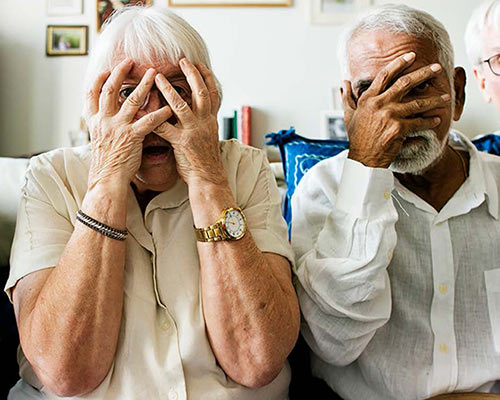 Two people covering their eyes.