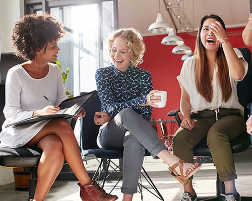Group of adults sitting in a conference room having a meeting. 