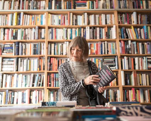 Woman holding a book in the library.