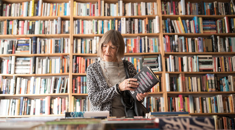 Woman holding a book in the library.