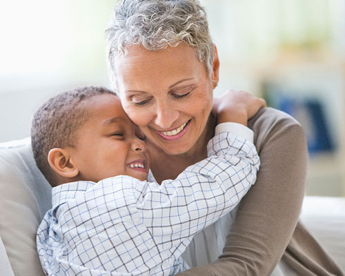 Young boy hugging his grandma.