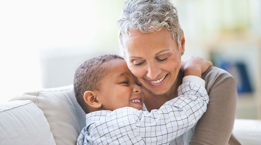 Young boy hugging his grandma.