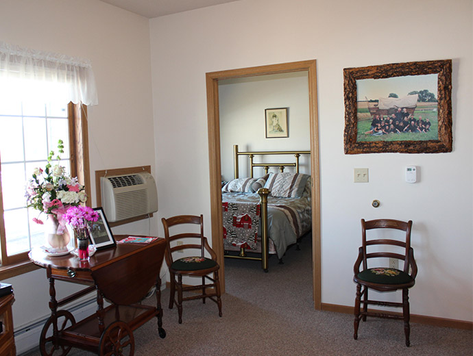 The spacious senior living apartments feature the bedroom opening up from the living room at Good Samaritan Society - Beatrice in Beatrice, Nebraska.