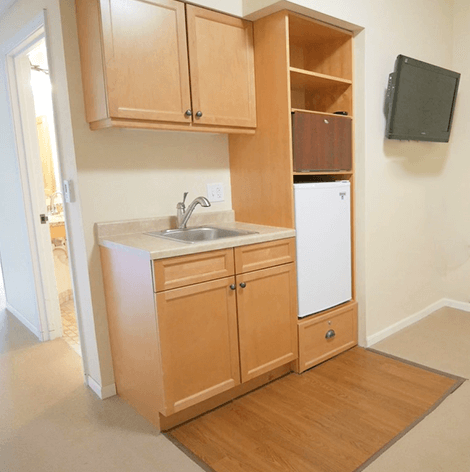 The basic studio apartments feature a small kitchenette at Good Samaritan Society - Augusta Place in Bismarck, North Dakota.