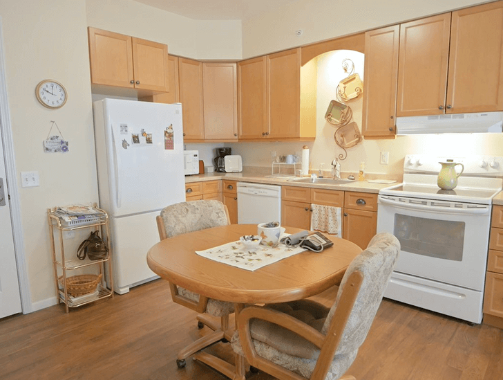 Independent living apartments feature a full kitchen with space for a small table at Good Samaritan Society - Augusta Place in Bismarck, North Dakota.