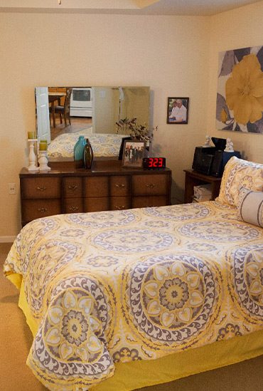 Large master bedroom with natural light at Good Samaritan Society - Augusta Place in Bismarck, North Dakota.