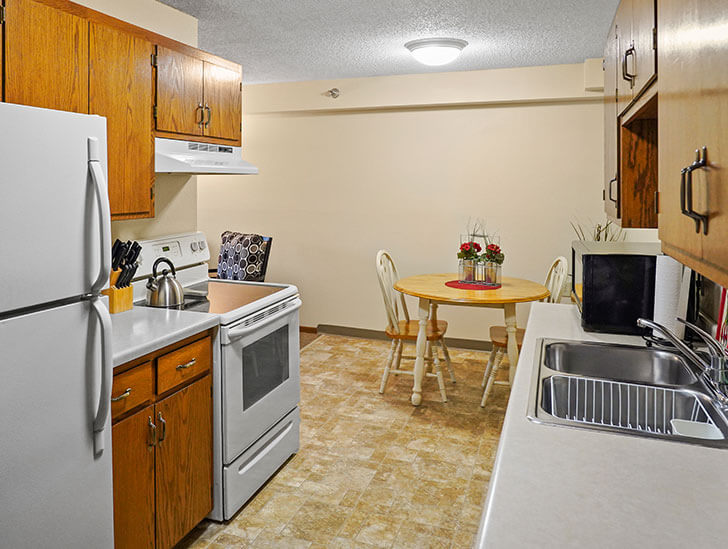The kitchen in a 2 bedroom assisted living apartment at Good Samaritan Society - Woodland in Brainerd, MN.