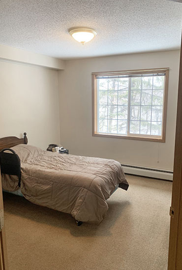 Independent living apartments include large bedrooms with natural light at Good Samaritan Society - Hidewood Estates in Clear Lake, South Dakota.