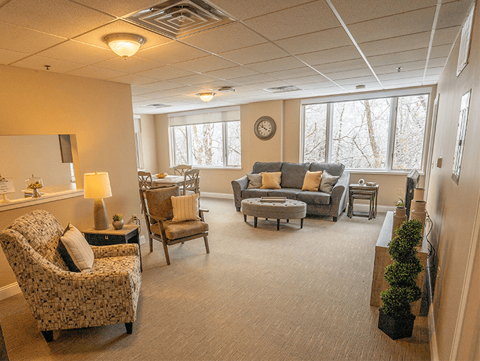 Large open concept living room with natural light and a spectacular view for independent living residents at Good Samaritan Society - Davenport in Davenport, Iowa.