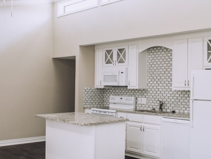 Spacious white kitchen available for independent living residents at Good Samaritan Society - Lake Forest Village in Denton, Texas.