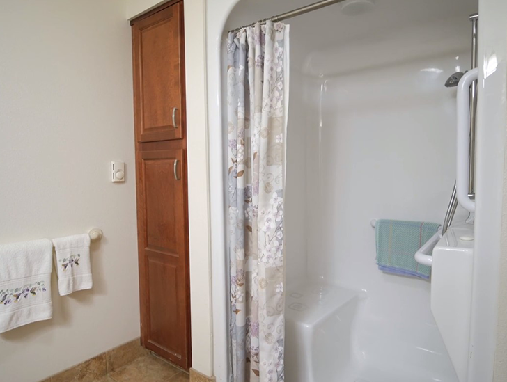 Good Samaritan Society - Grand Island Crane Meadows assisted living apartment bathroom with walk-in shower