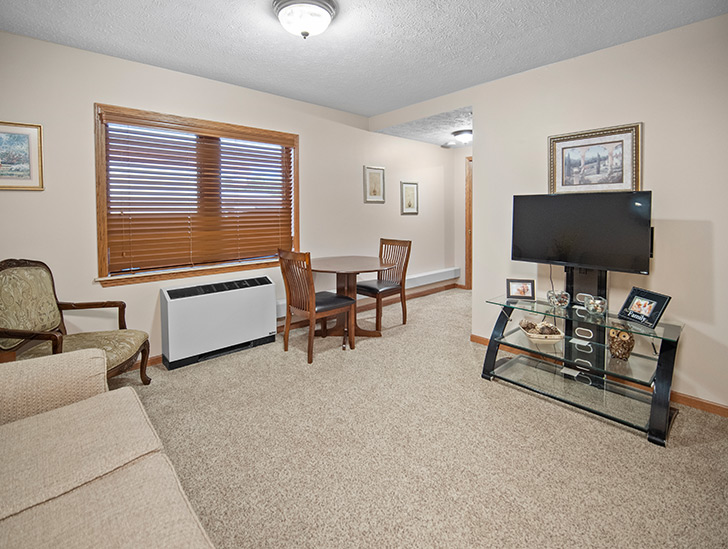 Spacious living room available in assisted living apartments at Good Samaritan Society - Hastings Village in Hastings, Nebraska.