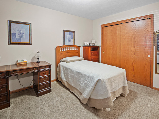 Spacious bedroom with closet in the assisted living apartments at Good Samaritan Society - Hastings Village in Hastings, Nebraska.