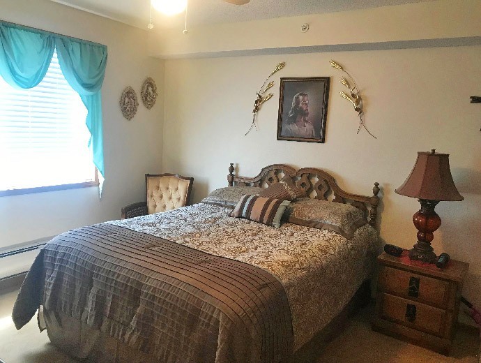 The Garden Terrace apartments feature a spacious master bedroom with natural light at Good Samaritan Society - Hays in Hays, Nebraska.