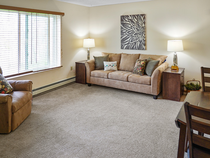 River's Edge independent living apartments feature naturally lit living rooms for entertaining at Good Samaritan Society - International Falls in International Falls, Minnesota.