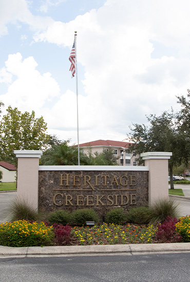 Entrance sign for Heritage Creekside assisted living apartments at Good Samaritan Society - Kissimmee Village in Kissimmee, Florida.