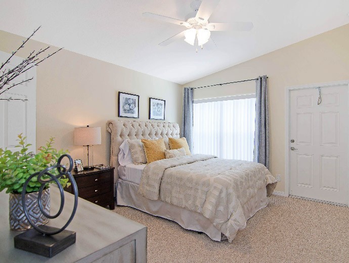 Large master bedroom with walk-in closet and spectacular view in Courtyard Villa apartments available at Good Samaritan Society - Kissimmee Village in Kissimmee, Florida.
