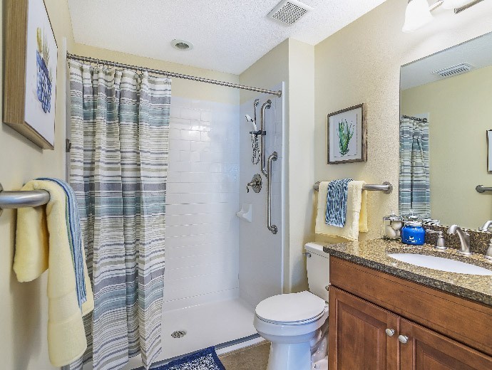 Large bathroom with walk-in shower located in Gables apartments available at Good Samaritan Society - Kissimmee Village in Kissimmee, Florida.