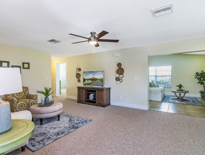 Large open family room with open concept into the spacious kitchen available within the Gables apartments at Good Samaritan Society - Kissimmee Village in Kissimmee, Florida.