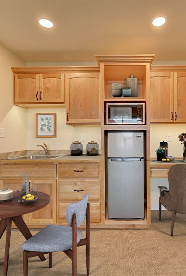 Furnished assisted living apartment kitchenette at Good Samaritan Society - Loveland Village in Loveland, Colorado.