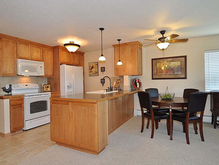 Full sized and updated kitchen that opens to the dining room in the independent living apartment at Good Samaritan Society - Loveland Village in Loveland, Colorado.
