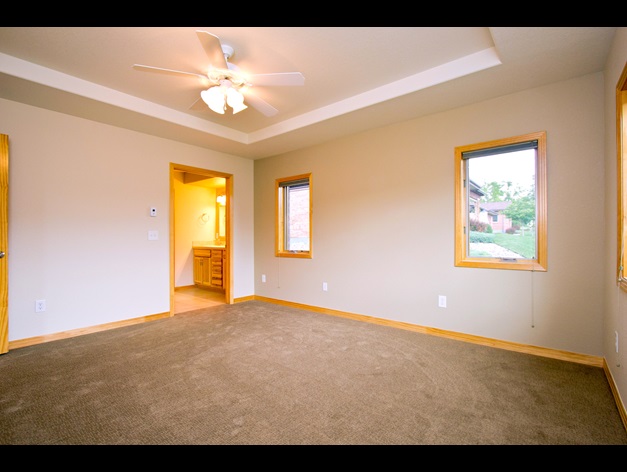 Spacious bedroom with walk-in bathroom in the independent living twin homes at Good Samaritan Society - Loveland Village in Loveland, Colorado.