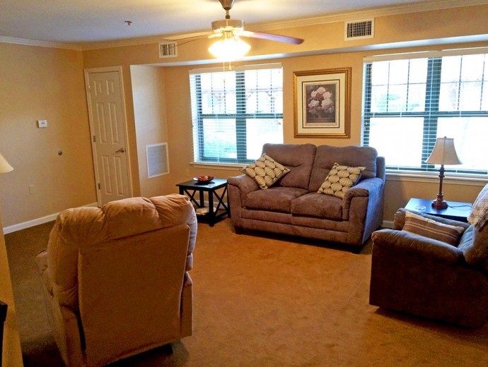 A spacious apartment living room with natural light is available at Good Samaritan Society - Mountain Home in Mountain Home, Arkansas.