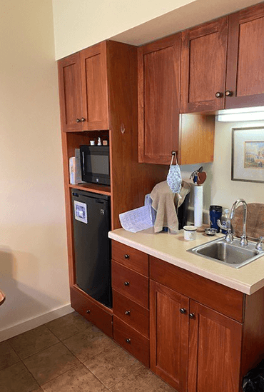 Timber Ridge Assisted Living apartment with a kitchenette including a fridge, microwave, sink and cupboard space.