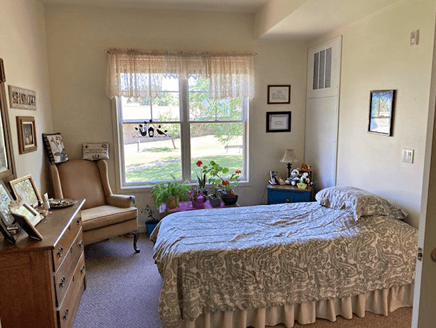 Timber Ridge Assisted Living apartment bedroom with natural light streaming in from the large window. Enough space for bedroom essentials.