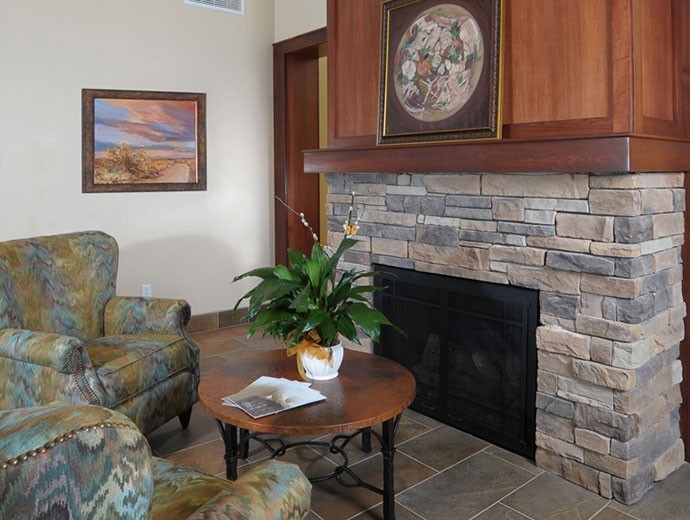 Cozy fireplace seating at Good Samaritan Society - Prescott Hospice and Marley House in Prescott, Arizona.
