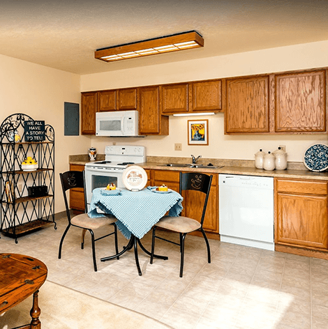 Spacious apartment kitchen with dining table at Good Samaritan Society - Prescott Village in Prescott, Arizona.