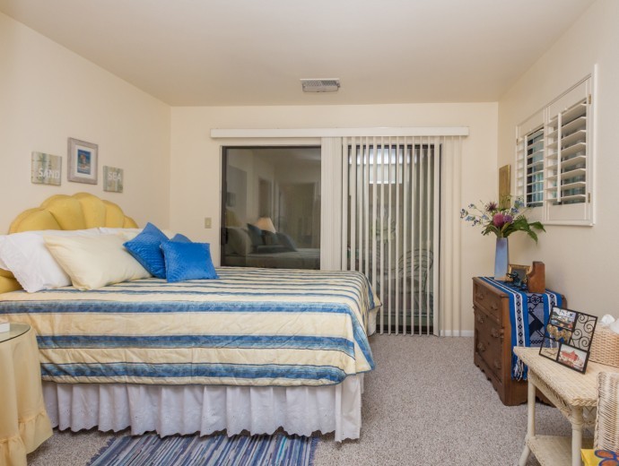 Master bedroom with walk-out patio at Good Samaritan Society - Prescott Village in Prescott, Arizona.