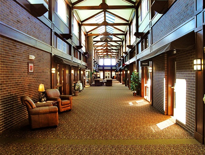Naturally lit lobby provides a community space for visitors and residents to gather at Good Samaritan Society - Sioux Falls Village in Sioux Falls, South Dakota.